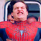Gif of Spiderman's scrunched face as he resists intense wind outside of some sort of travel vehicle