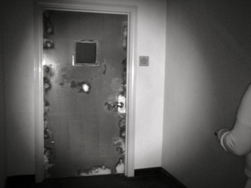 A door looks decayed under infrared light on the 4th floor of the Congress Plaza Hotel