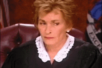Gif of an exasperated Judge Judy shaking her head and covering her face with her hand