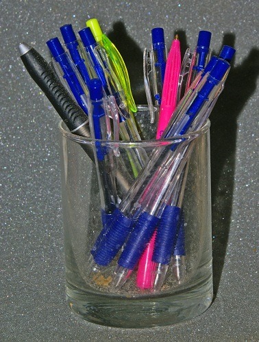 Organizing pens in a glass to avoid cluttering the desk