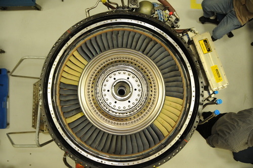 A turbine rotor with blades made from CMCs after the test. The yellow blades are covered with an environmental barrier for experimental purposes. Image credit: GE Aviation.