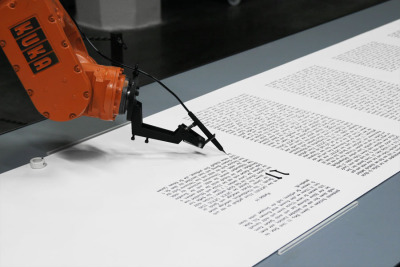 The installation &#8216;bios [bible]&#8217; consists of an industrial robot, which writes down the bible on rolls of paper. The machine draws the calligraphic lines with high precision. Like a monk in the scriptorium it creates step by step the text.Starting with the old testament and the books of Moses &#8216;bios [bible]&#8217;produces within seven month continuously the whole book.