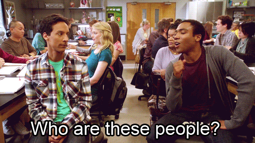 Gif of a a college student discreetly asking another, "Who are these people?"