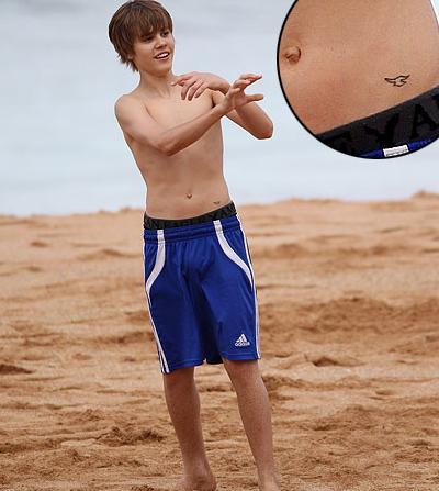 Justin has a tattoo on his lower stomach…and an outie belly button! Hold up!
