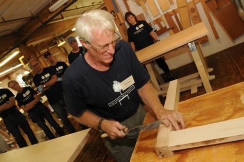 Chip Ogg demonstrates assembly of a table base.