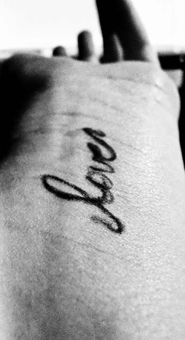 tattoos on wrist pain level. Wrist tattooed with lover text. Quirky, Interesting, Happy, creative. 