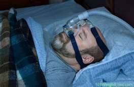 Man sleep soundly with CPAP machine