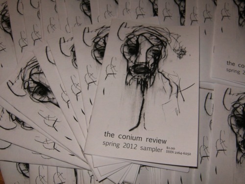 A pile of sampler booklets from "The Conium Review."