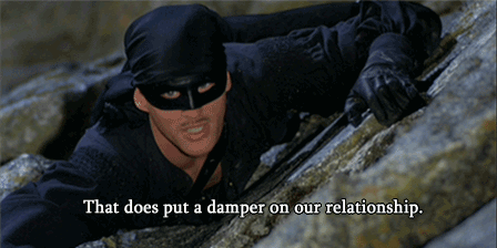 Gif of Zorro hanging on the side of a rock with the caption "That does put a damper on our relationship"