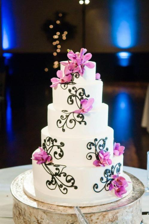 The beautiful wedding cake was perfectly detailed in black swirling sugar 
