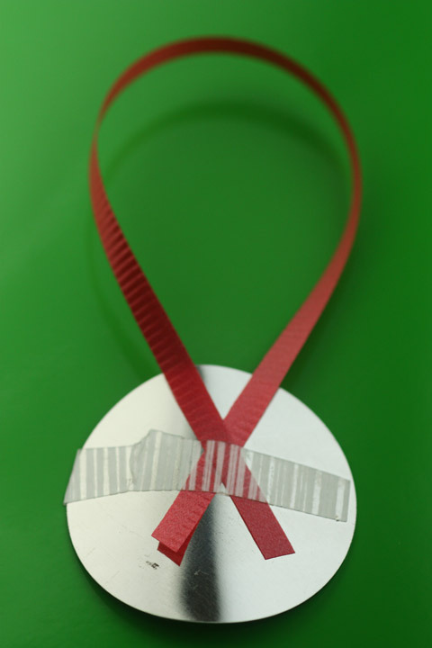 Attaching ribbon to a mirror button