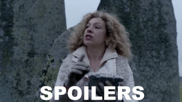 Animated gif of River Song, dressed in white and standing in front of Stone Henge, shushing someone and saying 'Spoilers'. White text at the bottom says 'Spoilers'.
