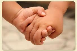Babies holding hands