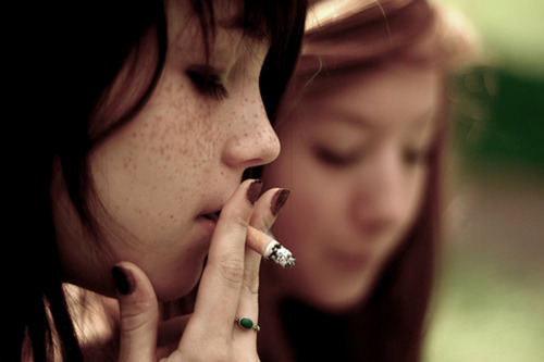 Very young little girls smoking cigarettes